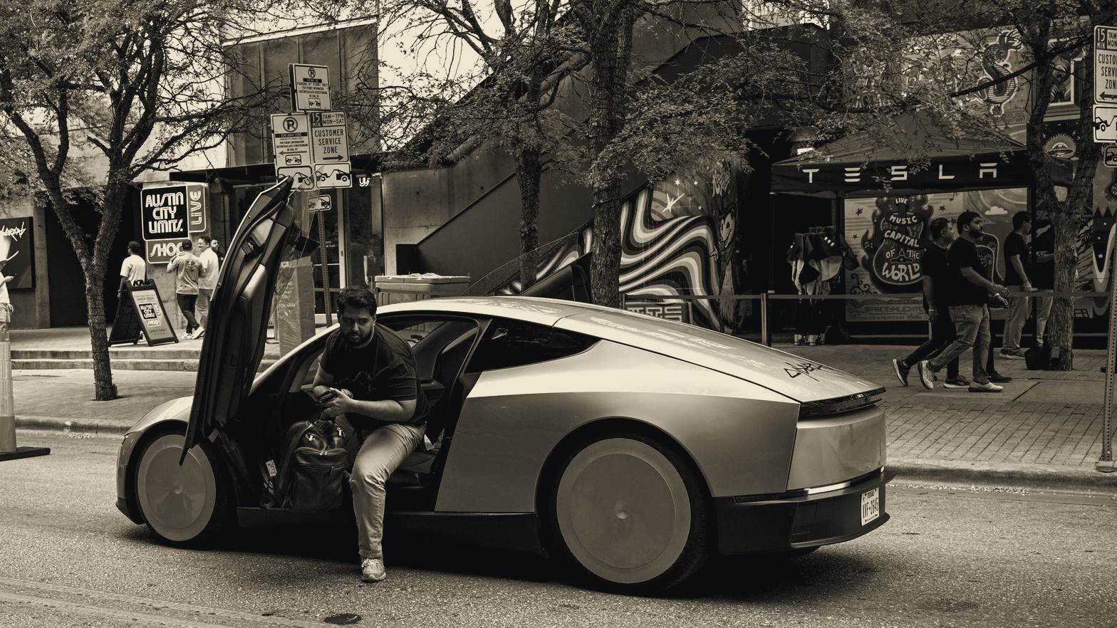 Tesla Cybercab with its gull-wing door open on a street in Austin, Texas